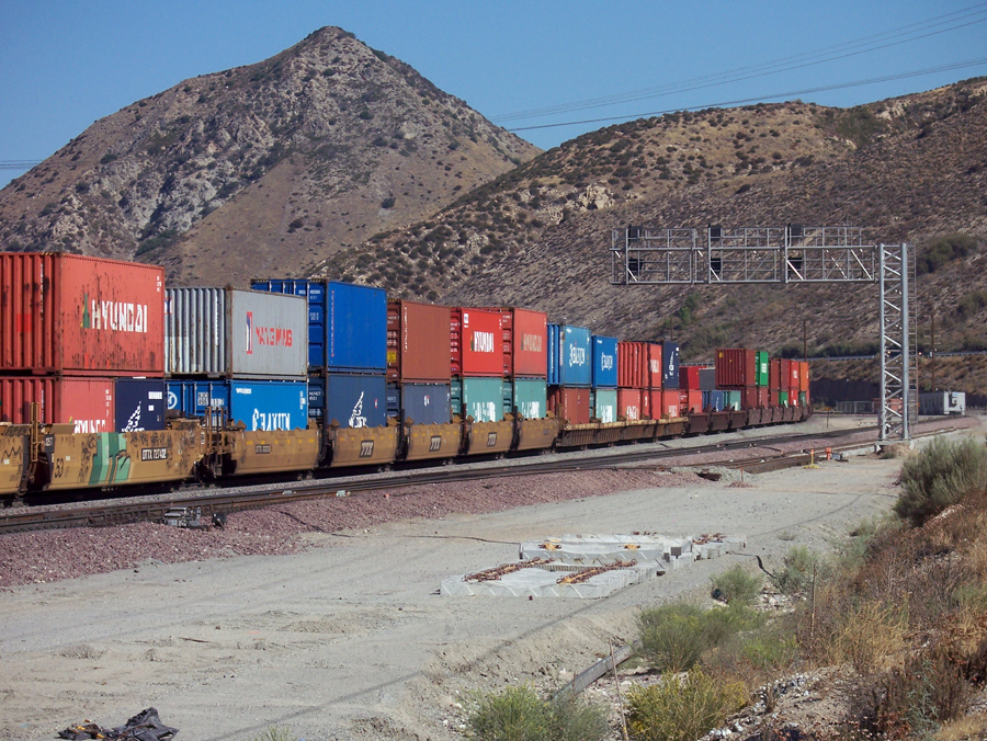 An intermodal freight train moving through Cajon Pass